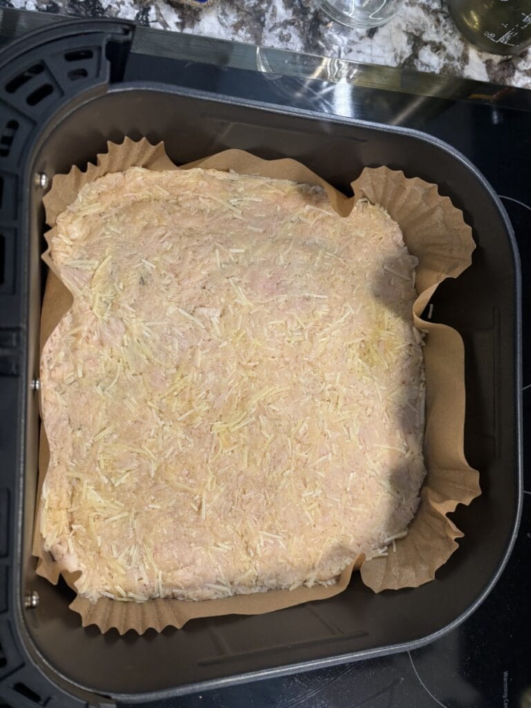 Chicken Crust Pizza "dough" pressed into Air Fryer Basket.