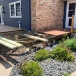 Note that the 4x4 posts are off the ground. This was done so that a bean could be added. Also note the big block of concrete under the 4x4 post. That will be going away. Right behind the concrete is a screw pier with another in the shadow towards the house. Screw piers installed.