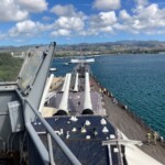 This is the view from the bridge area, looking over the forward gun turrets and at the Arizona memorial beyond. Battleship Missouri view of the Arizona Memorial