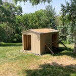 In this picture the scaffolding is in place, with plank. The roof sheathing is installed along with the drip edge. Scaffolding and finished roof