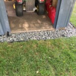 The required "before" picture showing the rocks in front of the door. East Door Before Concrete