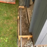 This picture shows the form in preparation for concrete. Note the gray pipe which is for drainage. Form and drainage in place