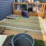 We built the frame on top of the packed limestone. The deck will NOT be attached to the main deck so it doesn't require footings. It just floats on the surface. Framing